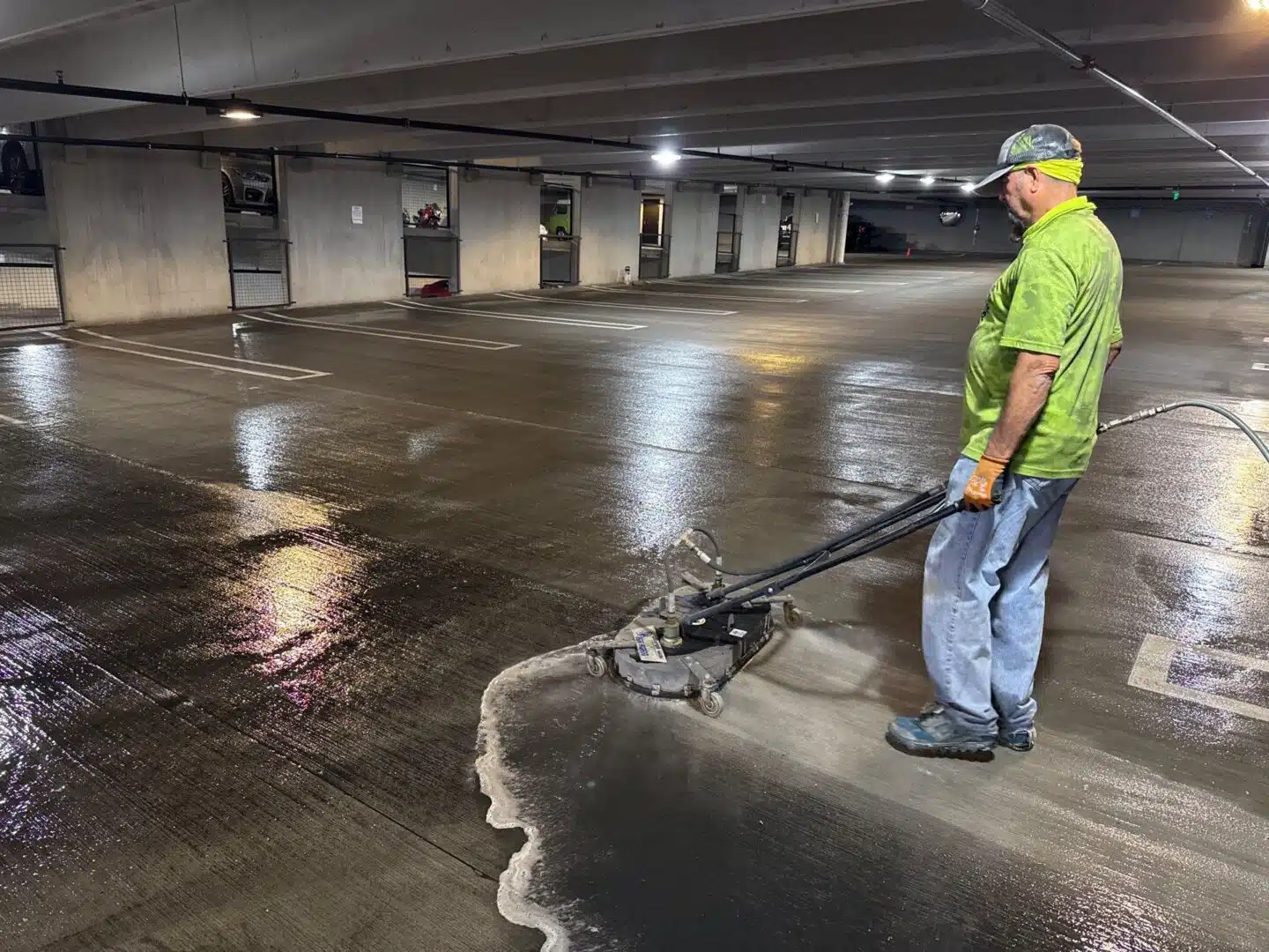 Pressure Power Pros technician hot water power washing a parking garage in Arizona